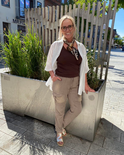 lene med brun top og brune bukser i lys nuance