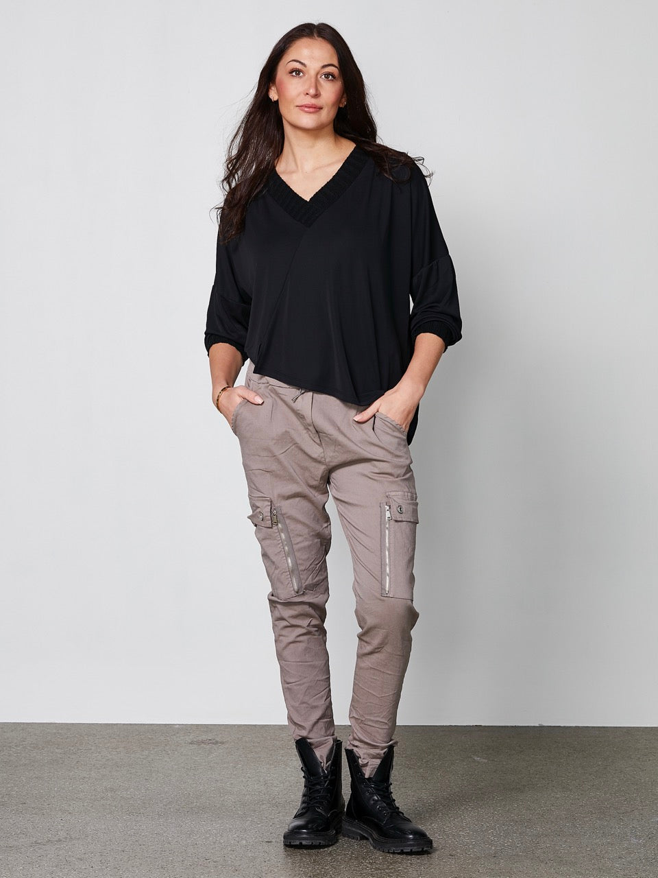 model med brune bukser med let baggy pasform, elastik i taljen og udvendige lommer på låret. NÜ Carmen Ynde Trousers Mud 8318-10