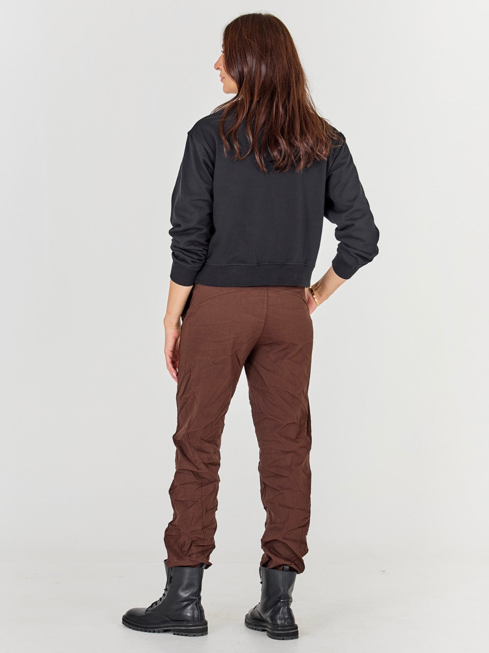 ryggen af model med sort sweatshirt med lynlås og broderi. NÜ Asis Sweat Black