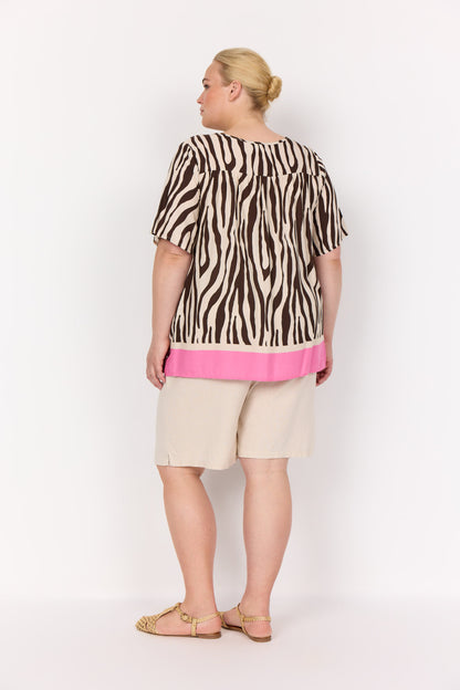 ryggen af model med kortærmet mønstret t-shirt med zebraprint og en pink kant forneden. Wasabi WA-MANDIE 1 T-shirt Hot Fudge Combi